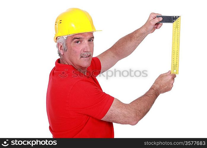 portrait of mature carpenter with meter isolated on white