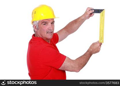 portrait of mature carpenter with meter isolated on white