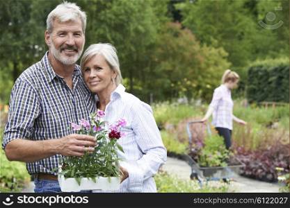 Portrait Of Mature Couple Shopping At Garden Center