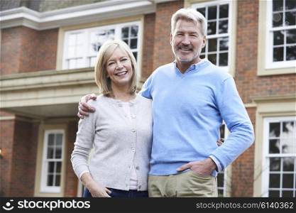Portrait Of Mature Couple Standing Outside Home