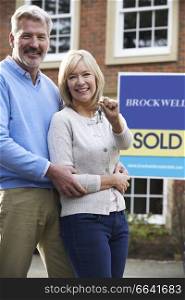 Portrait Of Mature Couple With Keys To New Home