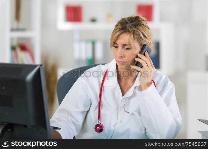 portrait of mature female doctor on the phone