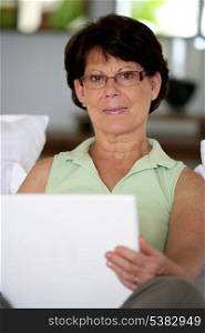 Portrait of mature lady with laptop