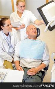 Portrait of mature man consultation with dentist surgeon stomatology clinic