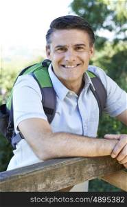 Portrait Of Mature Man Hiking In Countryside