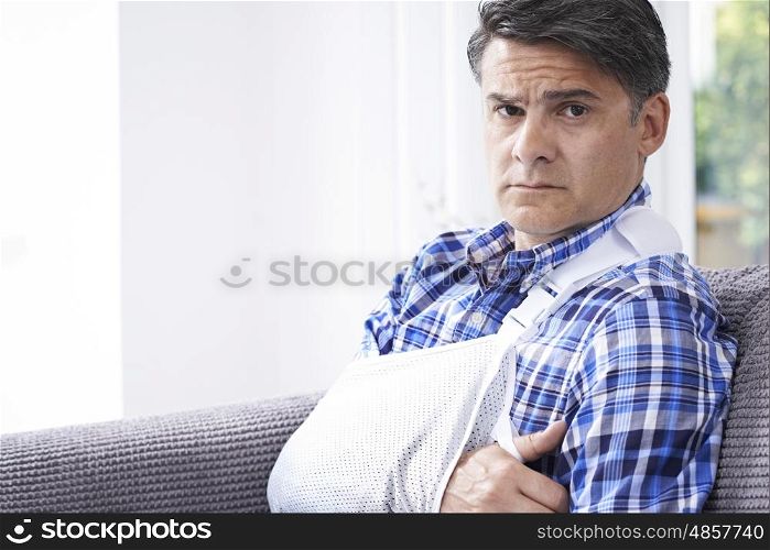 Portrait Of Mature Man With Arm In Sling At Home