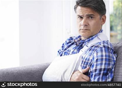 Portrait Of Mature Man With Arm In Sling At Home