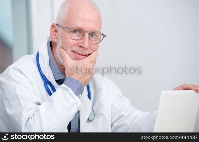 portrait of mature medical doctor with a stethoscope