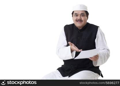 Portrait of mature politician holding document
