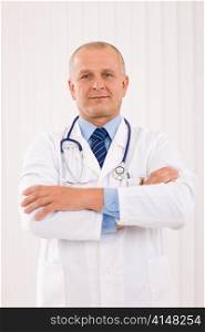 Portrait of mature professional doctor male with stethoscope crossed arms