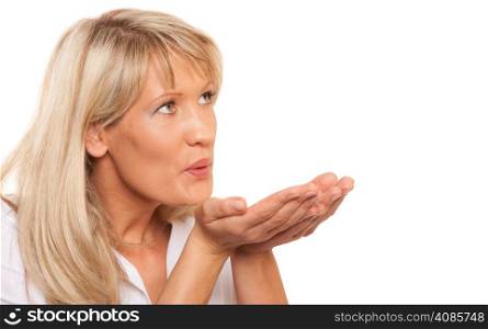 Portrait of mature woman blowing a kiss love symbol isolated on white background