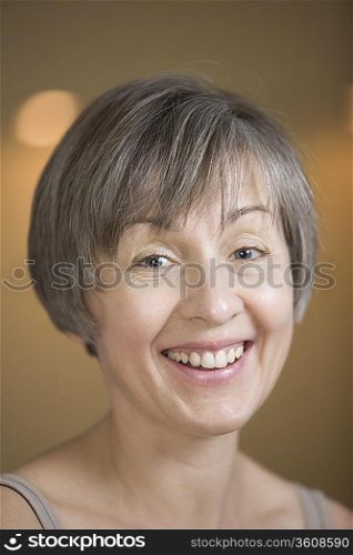 Portrait of mature woman with short grey hair laughing