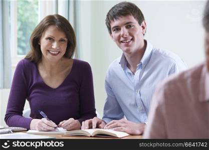 Portrait Of Mature Woman With Tutor In Adult Education Class
