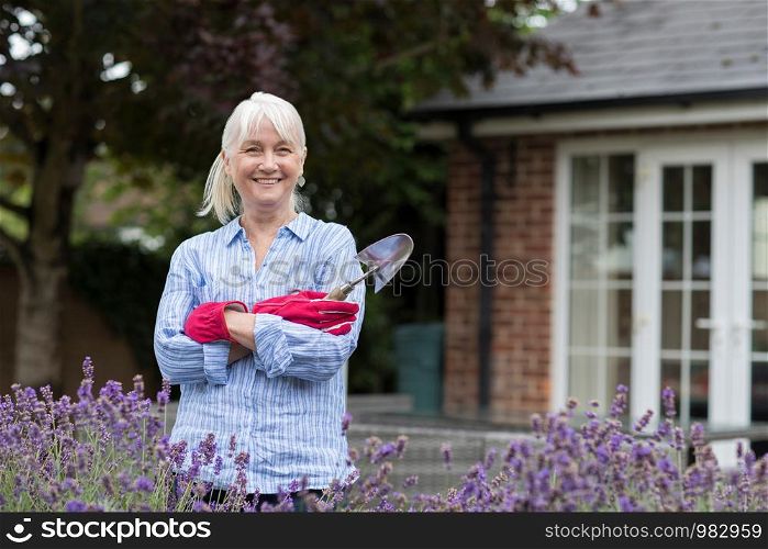 Portrait Of Mature Woman Working In Garden