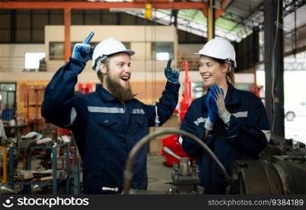 Portrait of mechanical engineers are checking the working condition of an old machine that has been used for some time. In a factory where natural light shines onto the workplace