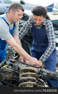 portrait of mechanics repairing a car