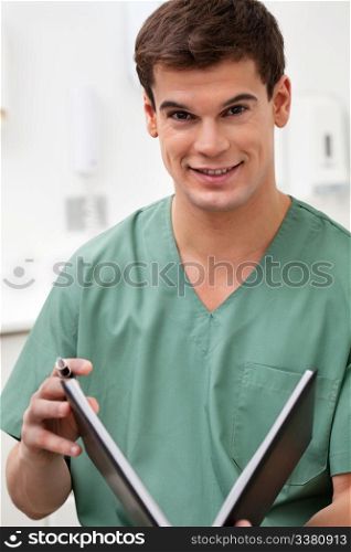 Portrait of medical practitioner holding a book and smiling
