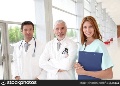 Portrait of medical team standing in hospital hall