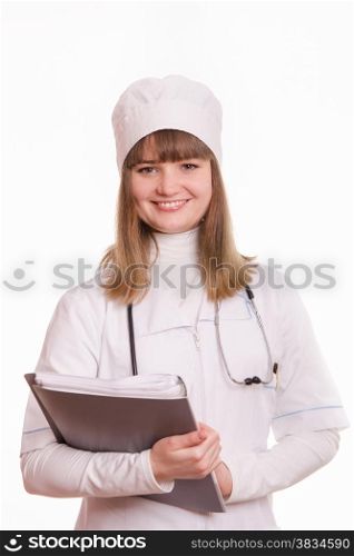 Portrait of medical worker in a white coat, hat, with documents
