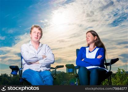 portrait of men and women 30 years of sitting in a chair outdoors