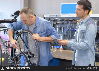 portrait of men assembling the bike
