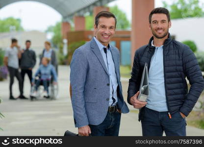 portrait of men outside library