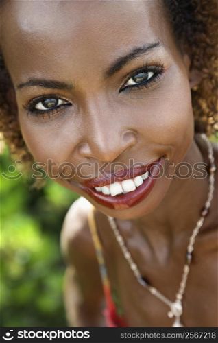 Portrait of mid-adult African American female smiling and making eye contact.