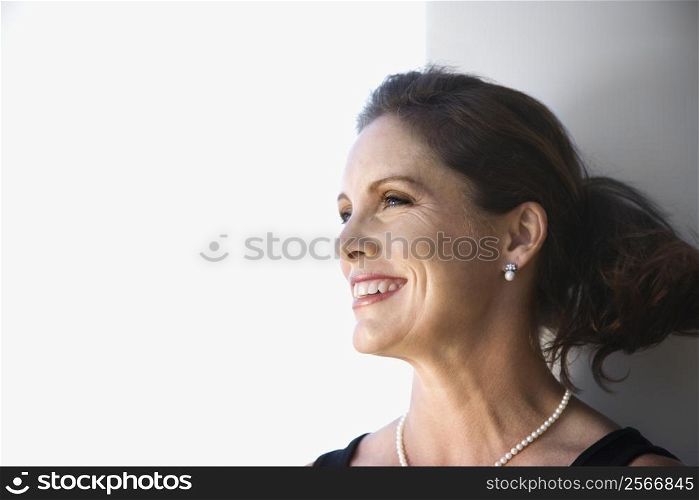 Portrait of mid-adult Caucasian female smiling and looking to side.