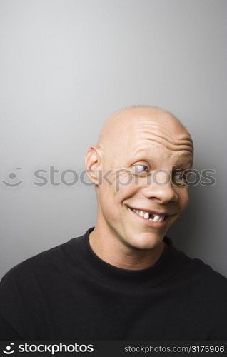 Portrait of mid-adult Caucasian male with missing tooth.