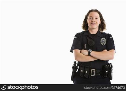 Portrait of mid adult Caucasian policewoman standing with arms crossed looking at viewer smiling.