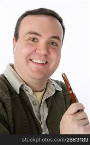 Portrait of mid-adult man holding pen, smiling