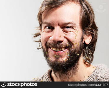 Portrait of mid adult man with stars on face against white background