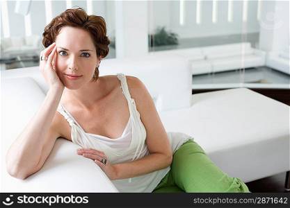Portrait of mid-adult woman on sofa