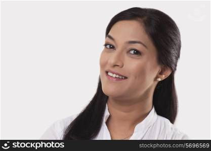 Portrait of mid adult woman smiling over white background