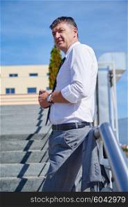 portrait of middle aged business man standing outdoor on stairs