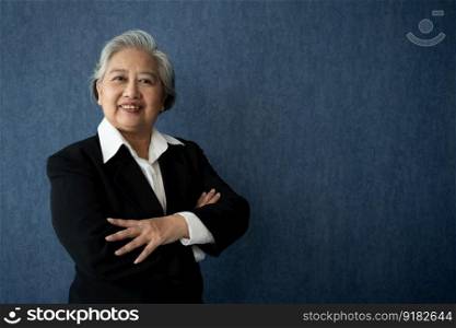 Portrait of middle aged business woman standing isolated on blue background and folded arms looking at the camera with a smile, Successful businesswoman, ceo, director, manager, banker, hr.