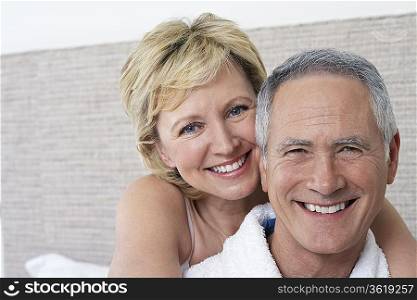 Portrait of middle-aged couple in bedroom, close-up