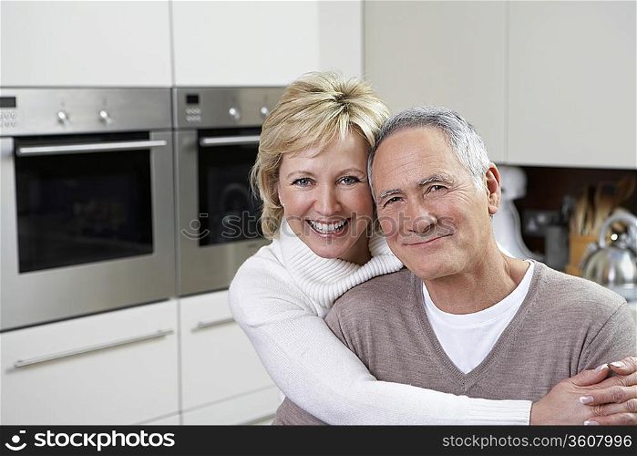 Portrait of middle-aged couple in kitchen