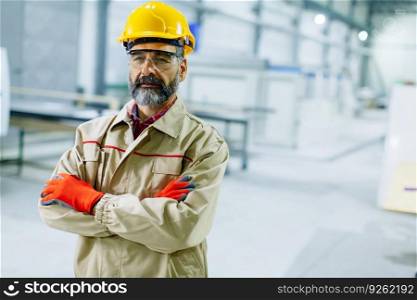 Portrait of middle-aged  engineer in factory