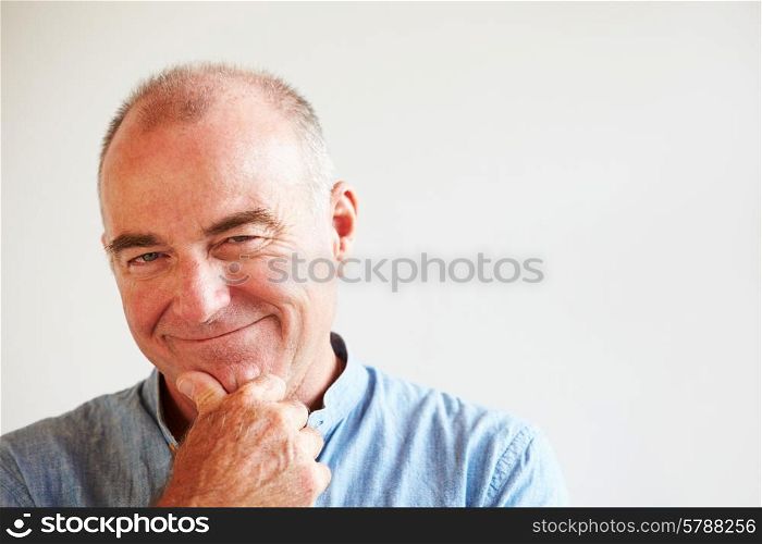 Portrait Of Middle Aged Man Standing By Wall