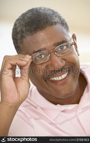 Portrait Of Middle Aged Man Trying On Glasses