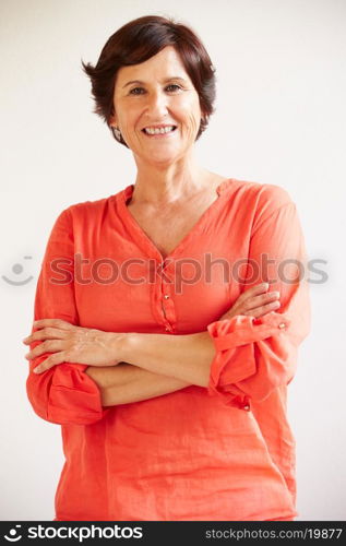 Portrait Of Middle Aged Woman Standing By Wall