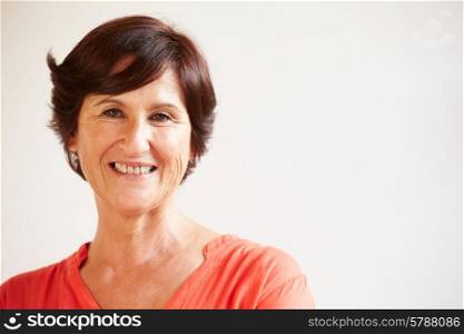 Portrait Of Middle Aged Woman Standing By Wall