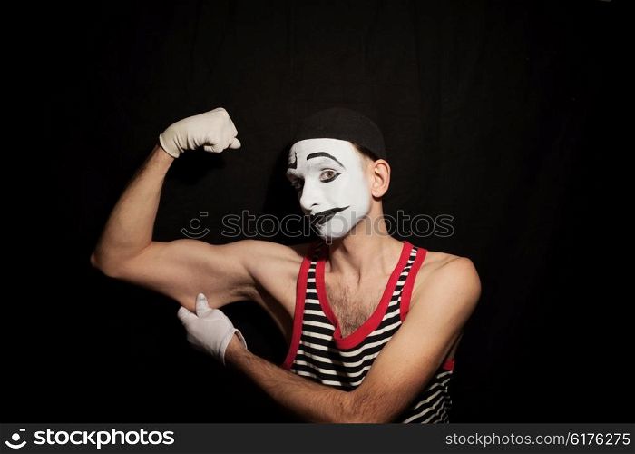 Portrait of mime actor on black background closeup