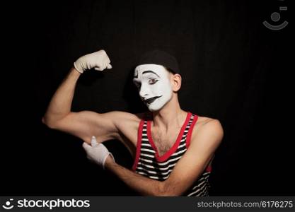 Portrait of mime actor on black background closeup