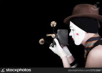 portrait of mime in white gloves and brown hat with camera