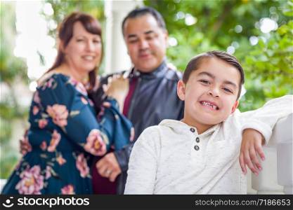 Portrait of Mixed Race Couple Standing Behind Young Son