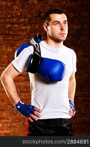 portrait of mma fighter against brick wall