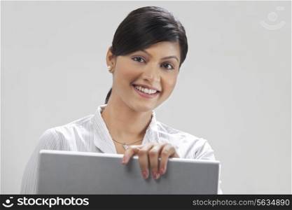 Portrait of modern businesswoman working on laptop