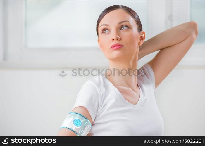 Portrait of modern healthy yoga woman wearing smart watch device with touchscreen